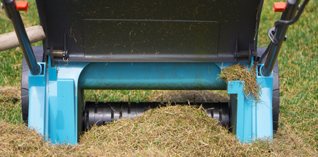Gardener Operating Soil Aeration Machine on Grass Lawn.の写真素材