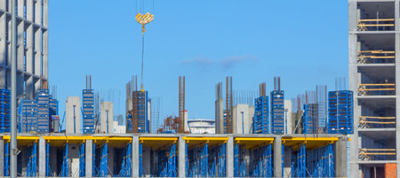 tower crane against the blue sky, the process of building a multi storey building