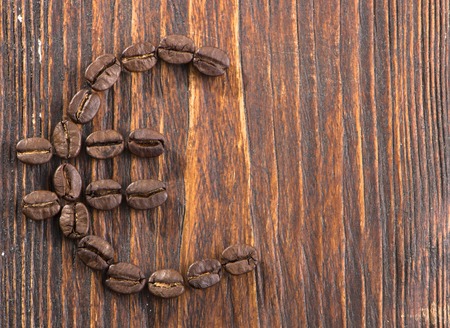 Sign of coffee seeds on a wooden backgroundの写真素材