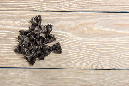 closeup of shaped butterfly pasta and hessian decoration on wooden backgroundの写真素材