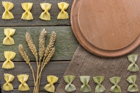 Spike of wheat and pasta, on a wooden background, with space for text top wiewの写真素材