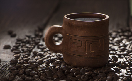 clay cup with coffee on the background of grains backgroundの写真素材