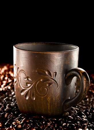 clay cup with coffee on the background of grains backgroundの写真素材
