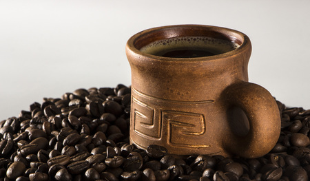 clay cup with coffee on the background of grains backgroundの写真素材