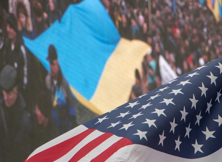flags of the USA and Ukraine against bright blue sky.の写真素材