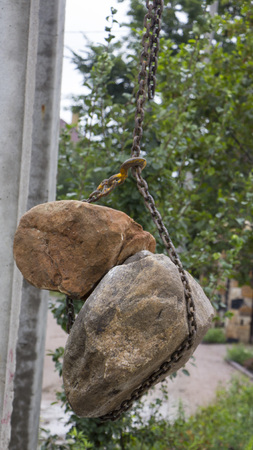 Delivery and unloading of building stone by truck with a craneの写真素材