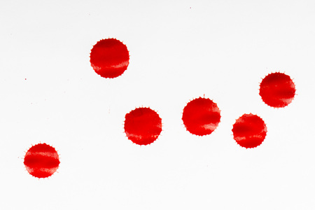 drops of red blood on white paperの写真素材