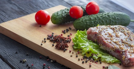 The process of cooking a steak, with all the ingredients on the table, selective focusの写真素材