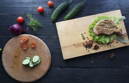 The process of cooking a steak, with all the ingredients on the table, selective focusの写真素材