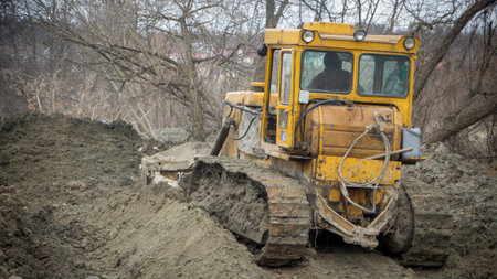 A large bulldozer digs a reclamation channel