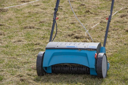 Gardener Operating Soil Aeration Machine on Grass Lawn.の写真素材