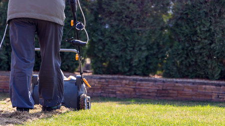 Gardener Operating Soil Aeration Machine on Grass Lawn