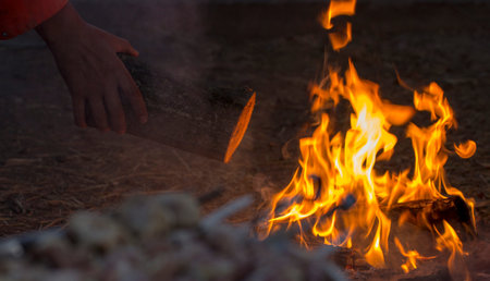 Fresh meat on a steel skewer in a smoke at brazier