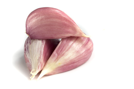 Three garlic cloves isolated on white backgroundの写真素材