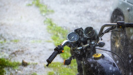 Drops of rain fall on parked vehicles in the parking lotの写真素材