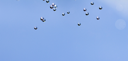 Close-up of water drops on glass surface as background.の写真素材