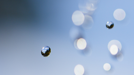 Close-up of water drops on glass surface as background.の写真素材