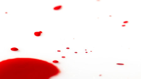 drops of red blood on white paper close up