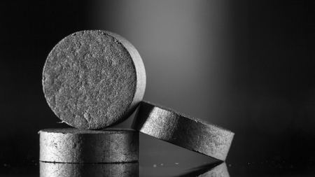 Medical drug, black tablet Activated carbon on a black background in backlight close upの写真素材