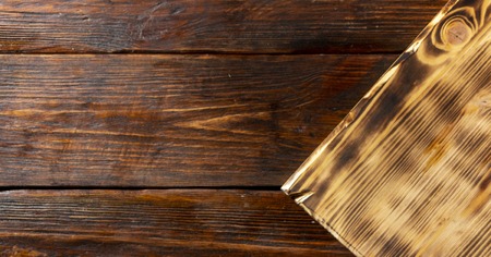 selective focus of stack of different wooden cutting boards on old wooden tableの写真素材