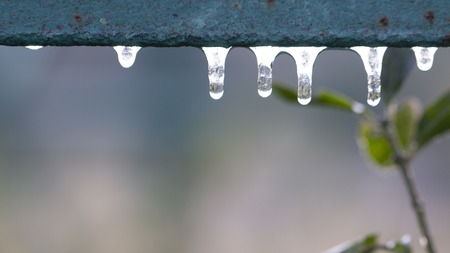 Small icicles on a nickel-plated handrail, the first autumn frosts.の写真素材