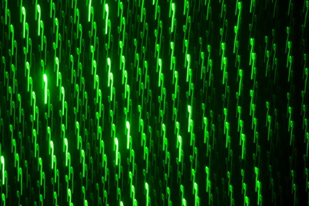 Drawing on a black wall with a green laser. Abstract drawing.の写真素材