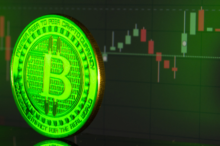 Bitcoin coin on the background graphics close upの写真素材