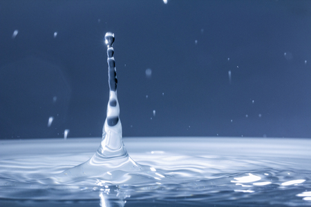 Drops of rain fall into the water, selective focus close upの写真素材