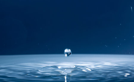 Drops of rain fall into the water, selective focus close up