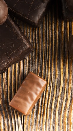 Chocolate candies on a wooden background. Close-upの写真素材