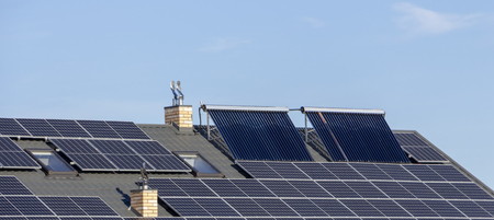 Solar installation for the generation of green electricity and water heating on the roof of a residential house close upの写真素材