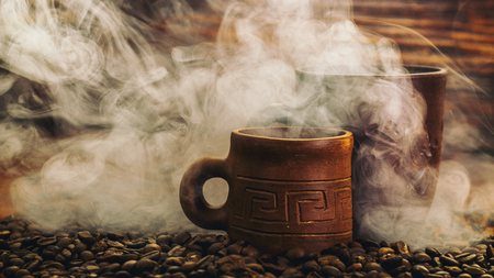 clay cup with coffee on the background of grains backgroundの写真素材