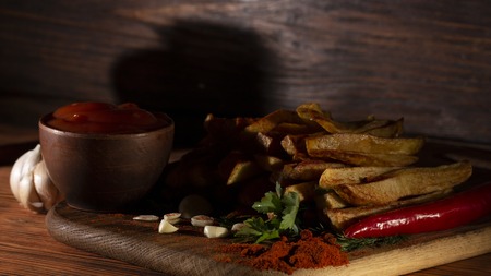 French fries on wooden table Selective focus, low key.の写真素材