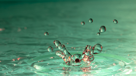 Drops of rain fall into the water, selective focus close upの写真素材