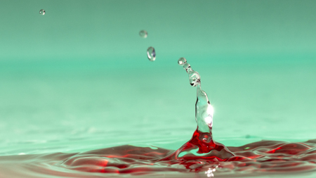 Drops of rain fall into the water, selective focus close upの写真素材