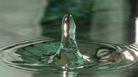 Drops of rain fall into the water, selective focus close upの写真素材