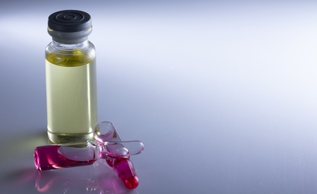 Medical ampoule and red-nose piglets on the light background close upの写真素材