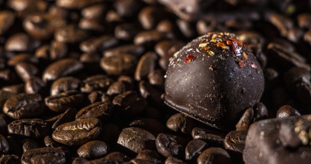 Chocolate pieces and coffee beans close up backgroundの写真素材