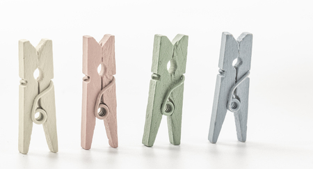 Colorful wooden clothespins on white background close upの写真素材