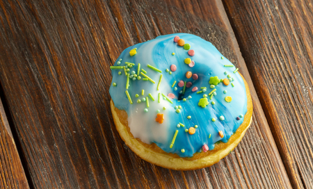 Fresh donut servedon the old wooden table with a clearly visible textureの写真素材