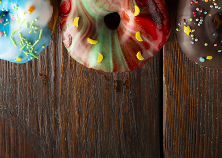 Fresh donut servedon the old wooden table with a clearly visible textureの写真素材