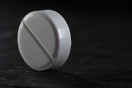One white pill on black background close upの写真素材
