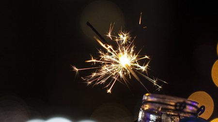 Flames of Bengal fire on the streets of the night city in defocus backgroundの写真素材