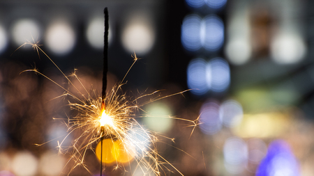 Flames of Bengal fire on the streets of the night city in defocus backgroundの写真素材