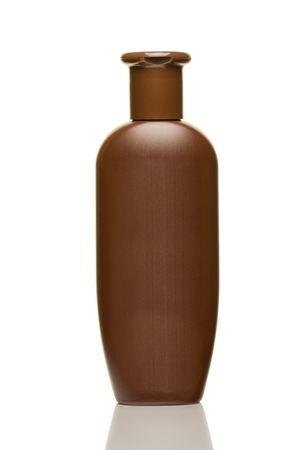 Brown plastic bottle for cosmetics isolated on white background close upの写真素材