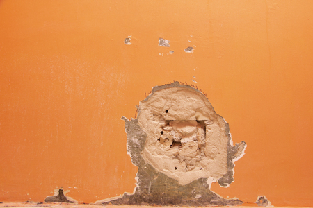 closeup of chipped paint on red wall backgroundの写真素材