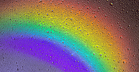 Drops of water on the glass, with the reflection of the rainbow. Backgroundの写真素材