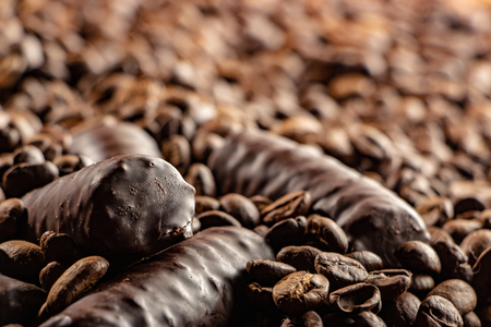 Chocolate pieces and coffee beans close up backgroundの写真素材