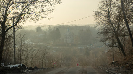 Morning country road in early spring with a small haze on the horizon