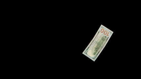 Flying dollars isolated on black background close up